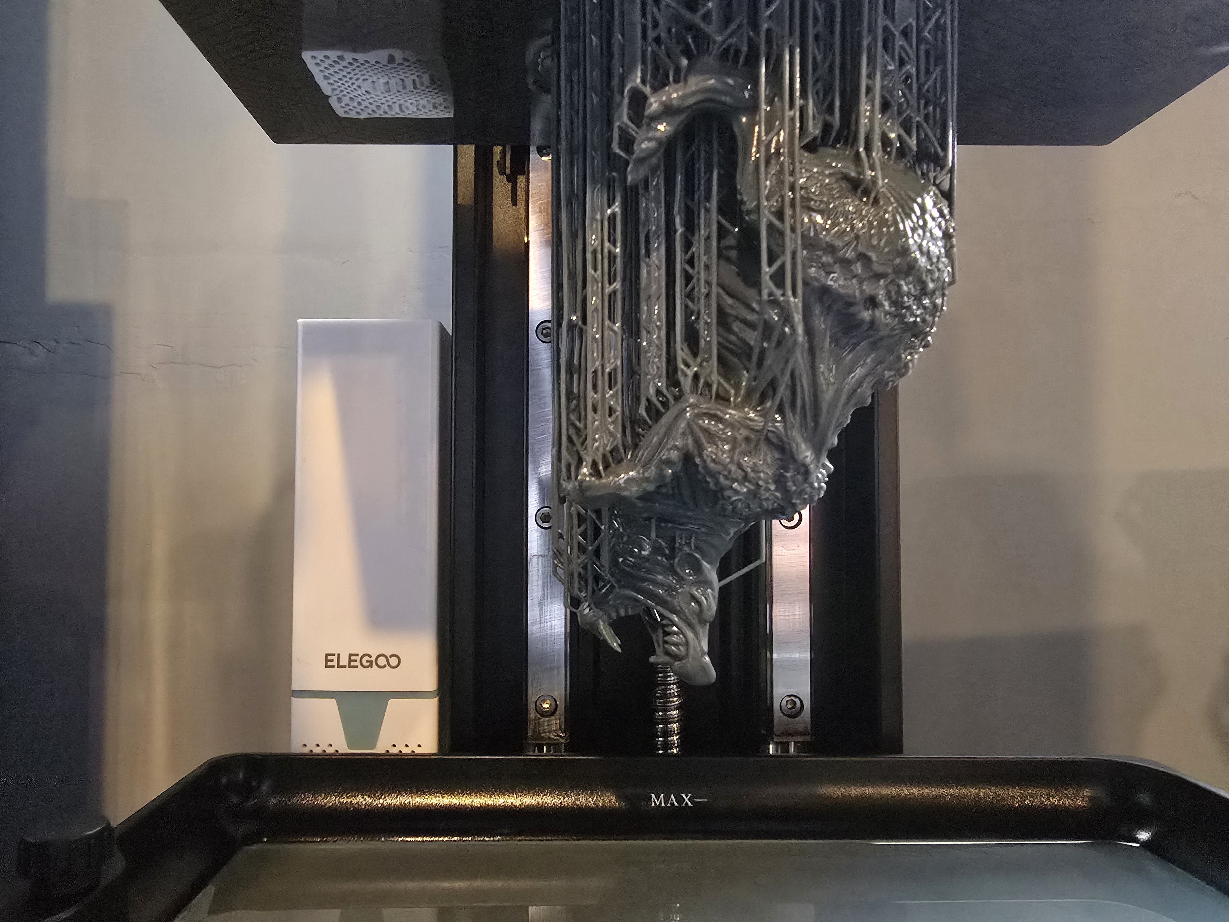 Resin print taking shape inside a fabrication machine.